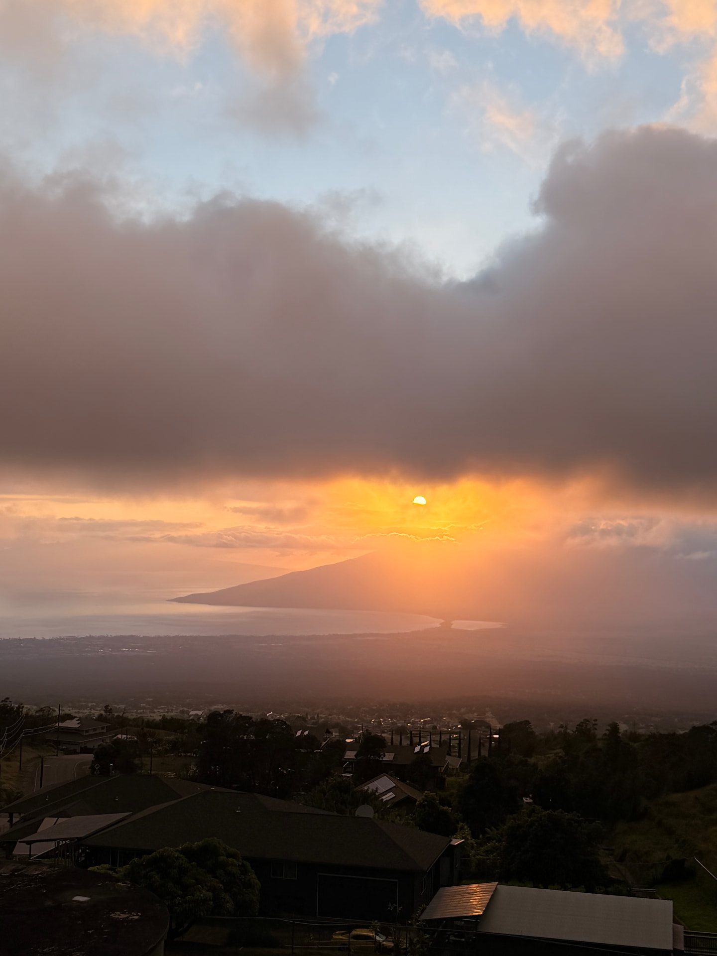 Sunset over West Maui and the ocean seen from the Kula hillside above town